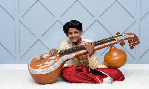 Rishi Sriskanthan, a versatile 13-year-old musician and Grade 7 student, has honed a unique talent of playing the Veena and Keyboard simultaneously, showcasing an impressive mastery uncommon for his age. Beyond his dedication to music, he also enjoys badminton and displays a broad knowledge in numerous subjects.